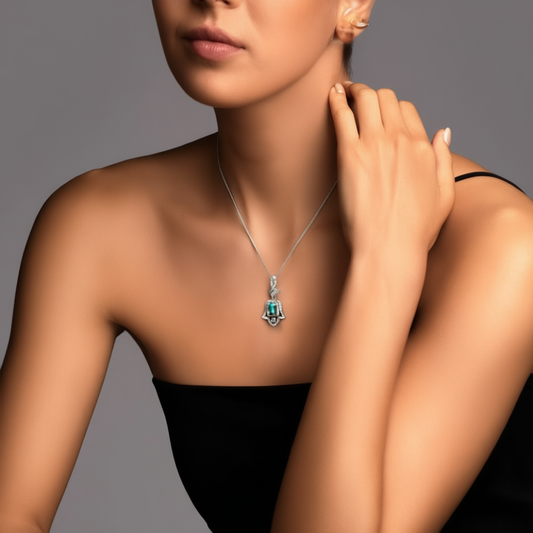 Detail of Amulet of Light pendant showing Hand of Fatima design and central green tourmaline