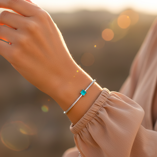 Detail of Green Essence bracelet showing central green tourmaline stone and delicate zircon setting