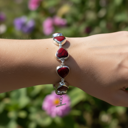 Detail of Heart of Fire bracelet showing carved red hearts and intense natural veining